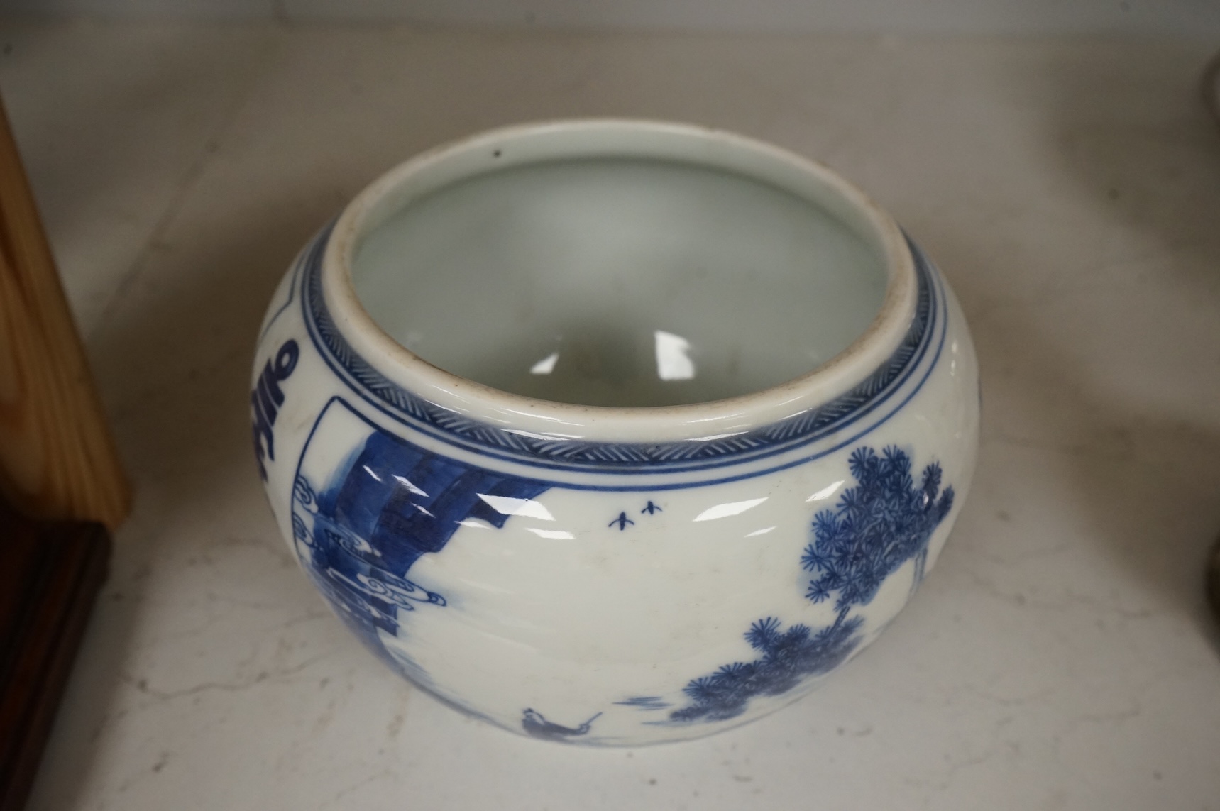 A Chinese blue and white water pot, decorated with two scenes in landscapes, 10.5cm high